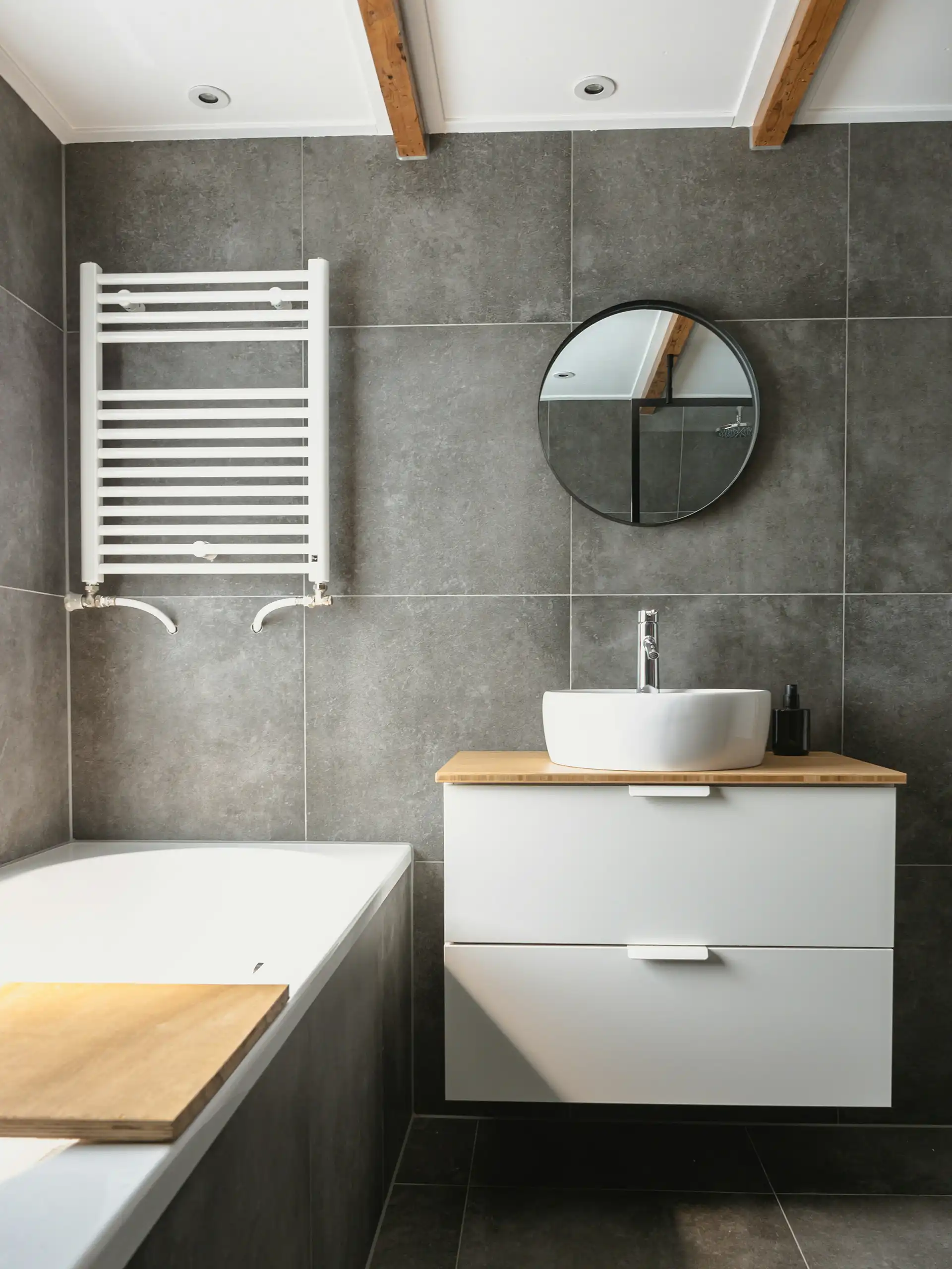 Minimal bathroom with white fixtures, toilet, and wall-mounted sink