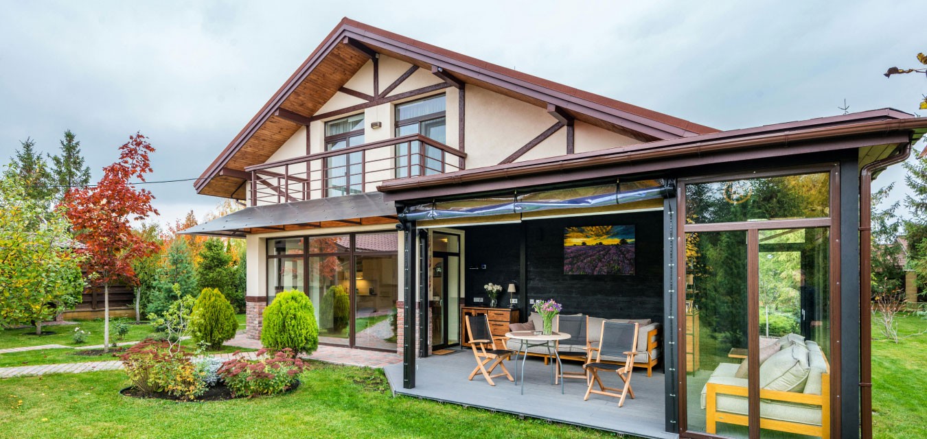 Modern house exterior with landscaped garden and paved driveway